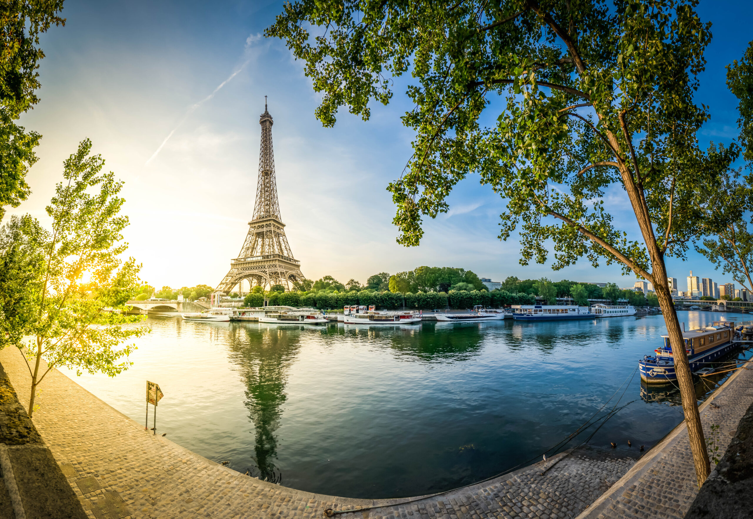 Paris Eiffel Tower and river Seine with sunrise sun in Paris, France. Eiffel Tower is one of the most iconic landmarks of Paris, panorama with sunshine